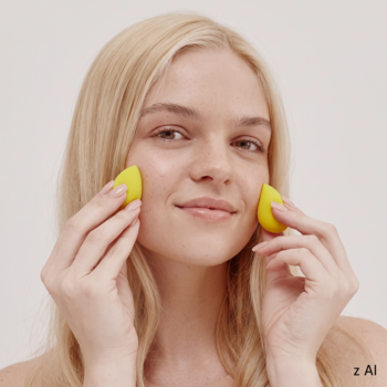 Blondynka używa żółtych gąbeczek GLOV Mini Mango Sponges do precyzyjnego makijażu na policzkach.