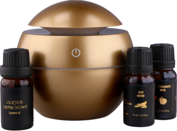 Złoty kulisty dyfuzor zapachowy z przyciskiem zasilania, w zestawie z trzema butelkami olejków eterycznych. Widok z przodu.