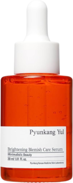Pyunkang Yul Brightening Blemish Care Serum w pomarańczowej butelce z białą pipetą, widok z przodu.
