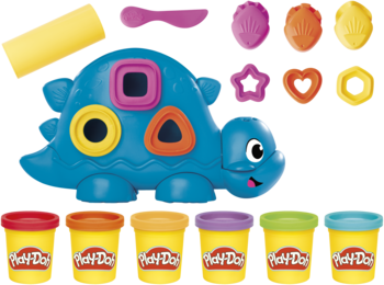 Zestaw Play-Doh Dinozaur z kształtami i kolorami: niebieski żółw-sorter, foremki i 6 tubek ciastoliny. Widok z góry.