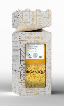 Organique: naturalne mydło i sole do kąpieli w ozdobnym, otwartym pudełku ze złotym świątecznym wzorem.