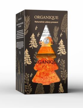 Organique, zestaw prezentowy z pomarańczową solą do kąpieli w kształcie choinki, ciemne pudełko ze złotymi drzewami.