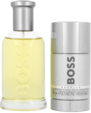 Zestaw BOSS Bottled: przezroczysta butelka perfum z żółtym płynem i srebrny dezodorant w sztyfcie, widok z przodu.