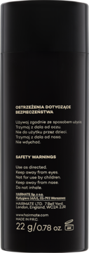 Tylna strona czarnego opakowania Hairmate, włókna do zagęszczania włosów, widoczne ostrzeżenia i waga.