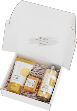 Zestaw Eternal Gold w otwartym białym pudełku: rozświetlający balsam, mydło i nektar do kąpieli.