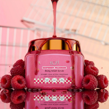Peeling do mycia ciała Fluff Raspberry Milkshake, różowy słoik, maliny i spływający malinowy płyn. Widok z góry.