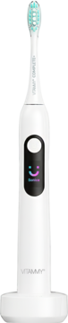 Biała szczoteczka soniczna VITAMMY Complete+ z inteligentnym wyświetlaczem smiley i niebieskim włosiem na stacji ładującej.