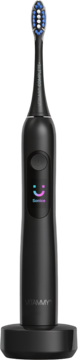 Czarna szczoteczka soniczna VITAMMY z wyświetlaczem smart i uśmiechem, stojąca na ładowarce USB-C.