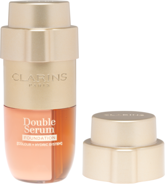 Clarins Double Serum Foundation, złoto-brązowa butelka z pompką, dwukomorowa, obok leży odkręcona zakrętka.