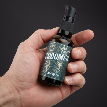 GROOMEN Beard Oil, mała butelka z pompką w męskiej dłoni, ciemne szkło, ozdobna etykieta, na czarnym tle.