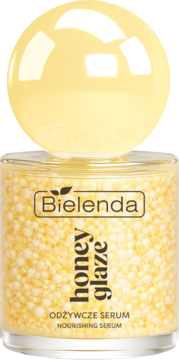 Bielenda Honey Glaze odżywcze serum w szklanym słoiku z żółtymi kuleczkami i okrągłą nakrętką.