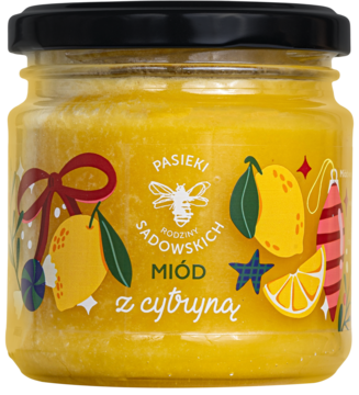 Miód z cytryną Pasieki Sadowskich w słoiku, z etykietą z cytrynami i świątecznymi ozdobami, widok z przodu.