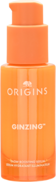 Pomarańczowa, półprzezroczysta butelka serum Origins GinZING z pompką, widok frontalny. Rozjaśniające serum z witaminą C.