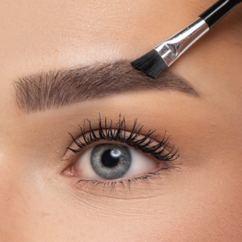 Zbliżenie na oko z brązowym pudrem do brwi Eye Brow Powder, aplikowanym pędzelkiem, dla naturalnego wyglądu.