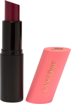 Lancôme Teint Idole Shape Stick Blush w odcieniu burgundu z otwartą, czarną bazą i różową nakrętką obok.