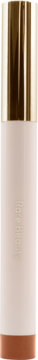 Rare B. All Weightless Eyeshadow Stick Adventure, cylindryczny. Złota nakrętka, beżowy korpus, miedziany spód.
