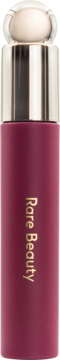 Rare Beauty tinted lip oil, deep berry matte bottle with metallic & clear cap, gold text, front view.
