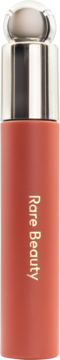 Rare Beauty Tinted Lip Oil: matte peachy-coral bottle with a metallic silver cap and clear spherical applicator.