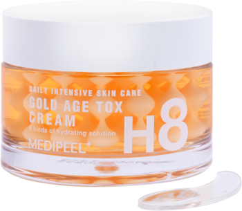 Medi-Peel Gold Age Tox Cream, przezroczysty słoik z żelem i złotymi kapsułkami H8, obok szpatułka.