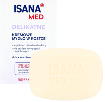 ISANA MED Delikatne kremowe mydło w kostce obok opakowania. Bladożółta kostka dla skóry wrażliwej, bezzapachowa, z wytłoczonym logo.