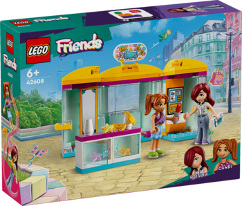 Pudełko LEGO Friends 42608 Mały sklep z akcesoriami. Widok z przodu na sklep z żółtym dachem i minilaleczki.