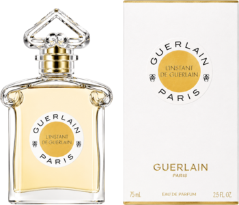 Guerlain L'Instant de Guerlain pour Homme, drzewna EDP w przejrzystej butelce z żółtym płynem obok białego pudełka.