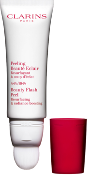 Clarins Beauty Flash Peel, biała tubka z peelingiem kwasowym, obok odłożona czerwona nakrętka.