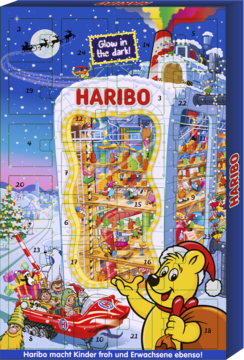 Haribo kalendarz adwentowy, świecący w ciemności, granatowy, z fabryką słodyczy i misiem Haribo w czapce Mikołaja.