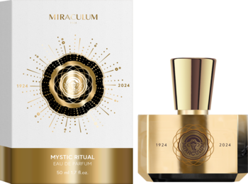 Złoty flakon i białe pudełko Mystic Ritual Eau de Parfum z promienistym, czarno-złotym wzorem na jasnym tle.