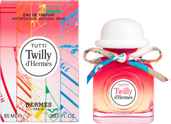 Hermès Tutti Twilly D'Hermès EDP, różowo-pomarańczowy flakon z wstążką i białym korkiem obok pudełka w paski.