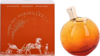 L'Ambre Des Merveilles Hermes woda perfumowana. Pomarańczowe pudełko z powozem i kulista butelka obok.