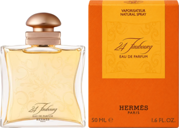 Kwiatowe perfumy 24 Faubourg Hermes EDP w szklanej butelce z żółtym płynem i złotą nakrętką obok pomarańczowego pudełka.
