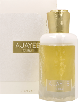 Perfumy AJAYEB DUBAI Portrait. Złocista butelka z bursztynowym płynem, obok białe pudełko z napisem.
