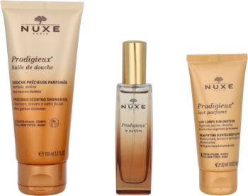 Zestaw Nuxe Paris Prodigieuse: pomarańczowa tuba olejku, złota butelka perfum i pomarażowy balsam do ciała.