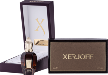 Zestaw perfum Xerjoff Ceylon: ciemna butelka, otwarta fioletowa szkatułka z logo X, obok brązowe pudełko.