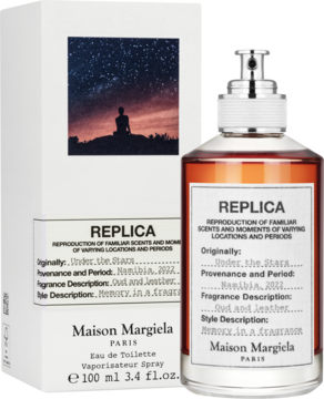 Replica Under the Stars, woda toaletowa unisex: bursztynowa butelka obok pudełka z motywem gwiezdnego nieba.