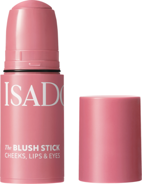 Kremowy róż IsaDora The Blush Stick Rose Perfect, otwarty, z odłożoną nakrętką, na jasnoróżowym tle.