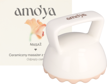 Biały ceramiczny masażer Amo'ya z wypustkami do ciała, z uchwytem, widok z przodu obok opakowania z kwiatem.