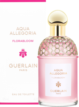 Różowa butelka Guerlain Aqua Allegoria Florabloom EDT, złoty korek plaster miodu, obok biało-różowe pudełko.