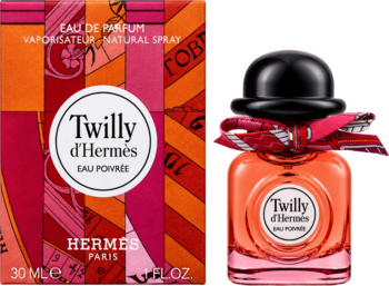 Hermès Twilly Eau Poivree, perfumy damskie. Pudełko i flakon z pomarańczowo-różową wstążką na pomarańczowym tle.