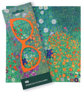 Pomarańczowe etui na okulary z wycięciem w kształcie oprawek, w folii, na kwiecistej reprodukcji obrazu.