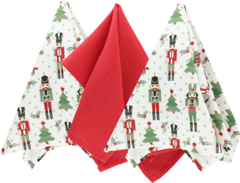 Zestaw ścierek świątecznych: białe z nutcrackerami i choinkami, oraz gładkie czerwone, częściowo złożone.
