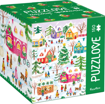Zielone pudełko Puzzlove Zimowe spotkania, 150 elementów. Widok pod kątem na zimową, ośnieżoną wioskę.