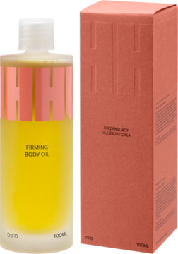 Hhuumm ujędrniający olejek do ciała 100ml, w butelce z żółtym płynem i różową etykietą, obok różowe pudełko.