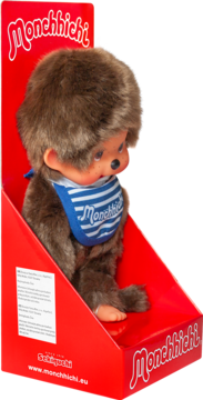 Monchhichi, urocza pluszowa małpka z brązowym futerkiem i niebieskim śliniakiem z logo, w czerwonym opakowaniu.