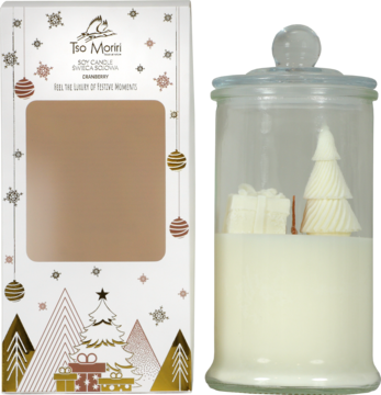 Szklana świeca sojowa Tio Moretti z figurką choinki i prezentu, obok pudełko świąteczne.