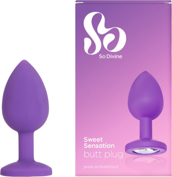 Fioletowy silikonowy korek analny So Divine Sweet Sensation z klejnotem, obok fioletowego opakowania produktu.