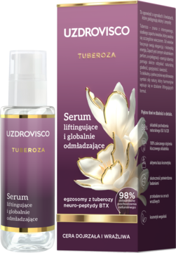 Serum UZDROVISCO Tuberosa liftingujące w butelce z pompką obok fioletowego pudełka z kwiatem tuberozy.
