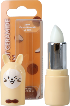 Balsam do ust Quret Coconut Ceramide w kremowym etui królika, otwarty, obok pomarańczowego opakowania z kokosami.