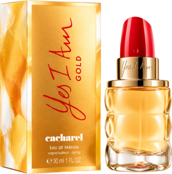 Damska woda perfumowana Cacharel Yes I Am Gold w złotej butelce przypominającej szminkę, obok złote pudełko.